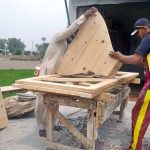 Carpenters are busy making wooden door at their workplace