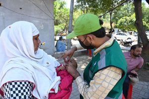 A polio worker administers drops to a child during an anti-polio drive at Dr Faisal Masood Teaching Hospital.