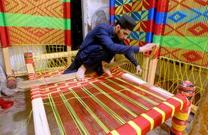 Workers busy in knitting traditional beds (Charpai) at their workplace near the Dabgari Area.