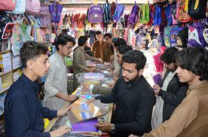 Youngsters buying school books at Archer Road following opening educational institutions in Balochistan.