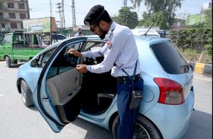 Traffic police wardens issue challans to motorcyclists without helmets during enforcement drive on Grand Trunk Road to ensure road safety compliance.