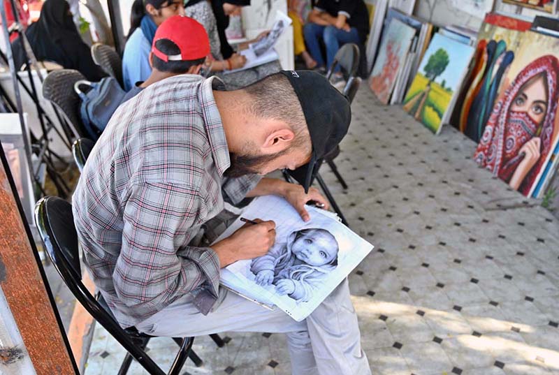 A student busy in making painting at Peshawar Mor Sunday Bazaar