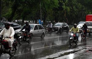 Motorcyclist covered himself with a plastic sheet to protect from rain that experienced in the Provincial Capital