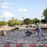 LDA workers are laying and fixing tuff tiles on a footpath as part of beautification work in the provincial capital