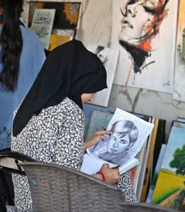 A student busy in making painting at Peshawar Mor Sunday Bazaar