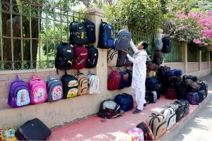 A vendor displays colourful bags on a footpath to attract customers at Daulat Gate.