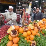 A roadside vendor preparing pomegranate juice for a customer at Qissa Khawani Bazar