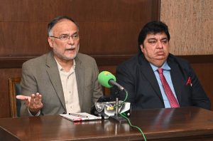 Federal Minister for Planning, Development and Special Initiatives Prof Ahsan Iqbal addressing a press conference at 180H Model Town