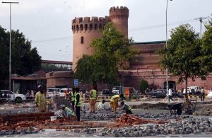 LDA workers are laying and fixing tuff tiles on a footpath as part of beautification work in the provincial capital