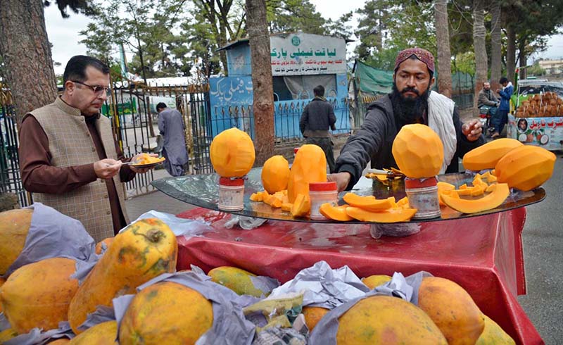A street vendor displays Papayas to catch the eye of passing customers