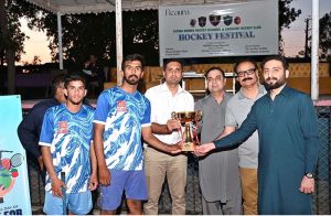 CEO Fieaura Malik Mohammad Hassan, senior hockey player Manzoor Hayder, and organizer Hassan Haider Shah distribute prizes to the winners during the closing ceremony of the Hockey Festival organized by Crescent Hockey Club and Fatima Women Hockey Academy at Austro Turf Hockey Stadium.