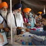 Indian Sikh yatrees exchanging money after arrive at wagha border as Thousands of Indian Sikh pilgrims (yatrees) arrived at the Wagah Border to celebrate the Vaisakhi Mela and the 327th birth anniversary of the Khalsa