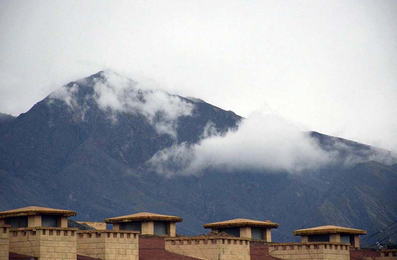 Clouds hovering on the surrounding mountains after a spell of heavy rain in the city