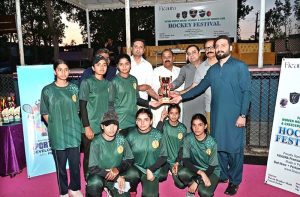 CEO Fieaura Malik Mohammad Hassan, senior hockey player Manzoor Hayder, and organizer Hassan Haider Shah distribute prizes to the winners during the closing ceremony of the Hockey Festival organized by Crescent Hockey Club and Fatima Women Hockey Academy at Austro Turf Hockey Stadium.