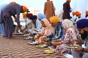 Indian Sikh yatrees exchanging money after arrive at wagha border as Thousands of Indian Sikh pilgrims (yatrees) arrived at the Wagah Border to celebrate the Vaisakhi Mela and the 327th birth anniversary of the Khalsa
