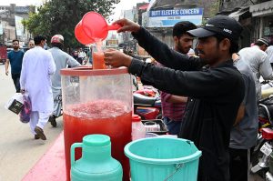 A Street vendor sells traditional drink on the roadside