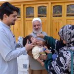 A health worker administers a polio vaccine to a child during a door-to-door vaccination campaign in at Zaryab colony faqirabad area