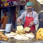 A street chef prepares tempting roll paratha at a roadside stall on Ferozepur Road in the city