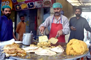 A street chef prepares tempting roll paratha at a roadside stall on Ferozepur Road in the city