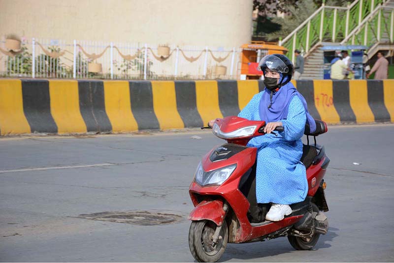 A woman on her way on electric scooty, nowadays a comfortable ride for women