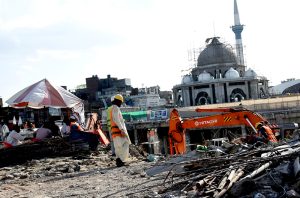 Labourers are busy in maintenance and restoration work at a historical shrine site.