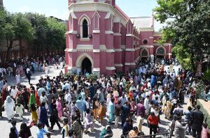 A large number of Christian faithful gather outside Don Bosco Church to take part in Easter celebrations.