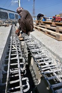 Labourers busy in repair work on the Railway over bridge Road.
