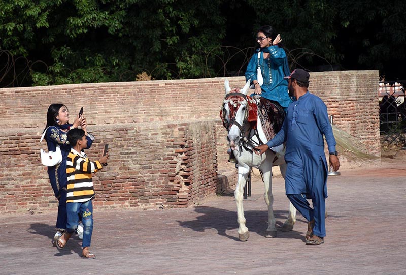 A girl enjoys horse ride at the historic Shahi Qila
