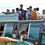 A large number of Children traveling on the rooftop of a passenger bus at Sachal Colony Road may cause any mishap and needs the attention of concerned authorities