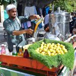 A vendor is preparing traditional summer drink to attract the customers at his setup