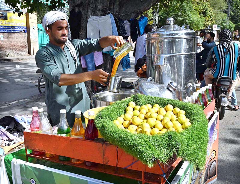 A vendor is preparing traditional summer drink to attract the customers at his setup