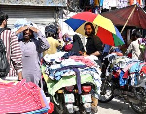 A vendor is busy filling air in plastic swimming pool at his roadside setup to attract the customers in Provincial Capital