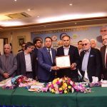 Office bearers of the Karachi Chamber of Commerce and Industry (KCCI) present a shield to Minister of State for Finance Bilal Azhar Kayani