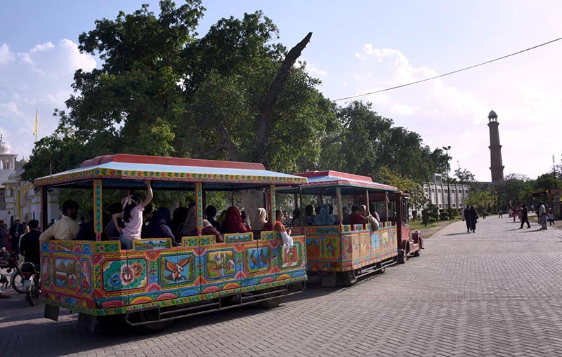 People enjoying a tram ride at Greater Iqbal Park