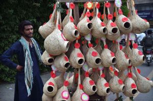 A vendor is waiting for customers to sell fresh flower hand garlands on the roadside in the provincial capital