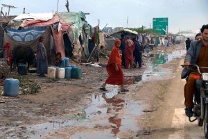 Motorcyclists passing through rain water accumulated on the road after rain that experienced the Provincial Capital