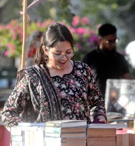 Women are busy selecting and purchasing old books from a stall at Frere Hall