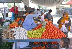 Vendor selling vegetable to customer at I/9 Bazaar in Federal Capital