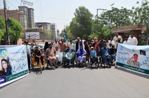 Persons with disabilities under the banner of the Society for Special Persons participate in a rally to commemorate Marka-e-Haq and express solidarity with the Pakistan Armed Forces