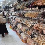 Women select and purchase sandals at H-9 Bazaar in the Federal Capital