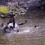 Children bathe in the water of Korang Nullah to cool off during intense hot weather, as soaring temperatures continue to affect daily life in the city