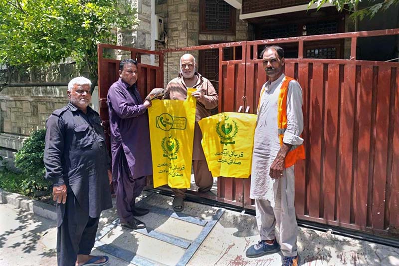 Cantonment Board staff in Walton distribute plastic bags for disposing of animal waste during Eid-ul-Adha