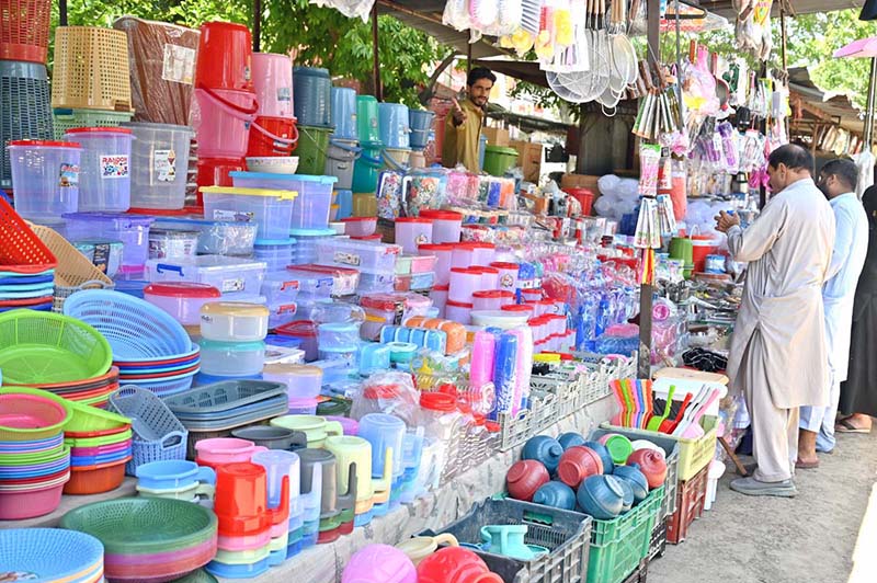 A vendor displaying different plastic items to attract the customers at I/9 Bazaar in Federal Capital