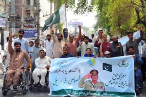 Persons with disabilities under the banner of the Society for Special Persons participate in a rally to commemorate Marka-e-Haq and express solidarity with the Pakistan Armed Forces