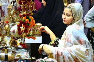 Women are busy selecting and purchasing artificial jewelry from vendor stall in preparation of Eid-ul-Azha at Resham Bazaar