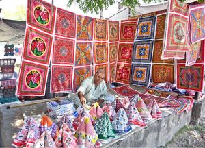 A vendor displaying different plastic items to attract the customers at I/9 Bazaar in Federal Capital