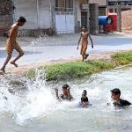 Youngsters are bathing in canal at Shamsher Town to get some relief from hot weather in the city
