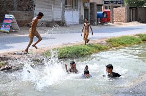 Youngsters are bathing in canal at Shamsher Town to get some relief from hot weather in the city