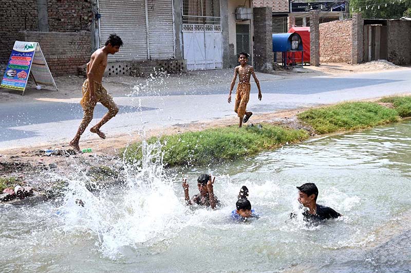 Youngsters are bathing in canal at Shamsher Town to get some relief from hot weather in the city