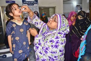 A health worker administers polio drops to a child during the ongoing anti-polio campaign in the city.
